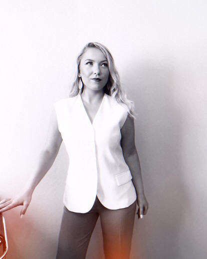 Photoshoot woman posing in front of chair in her office 